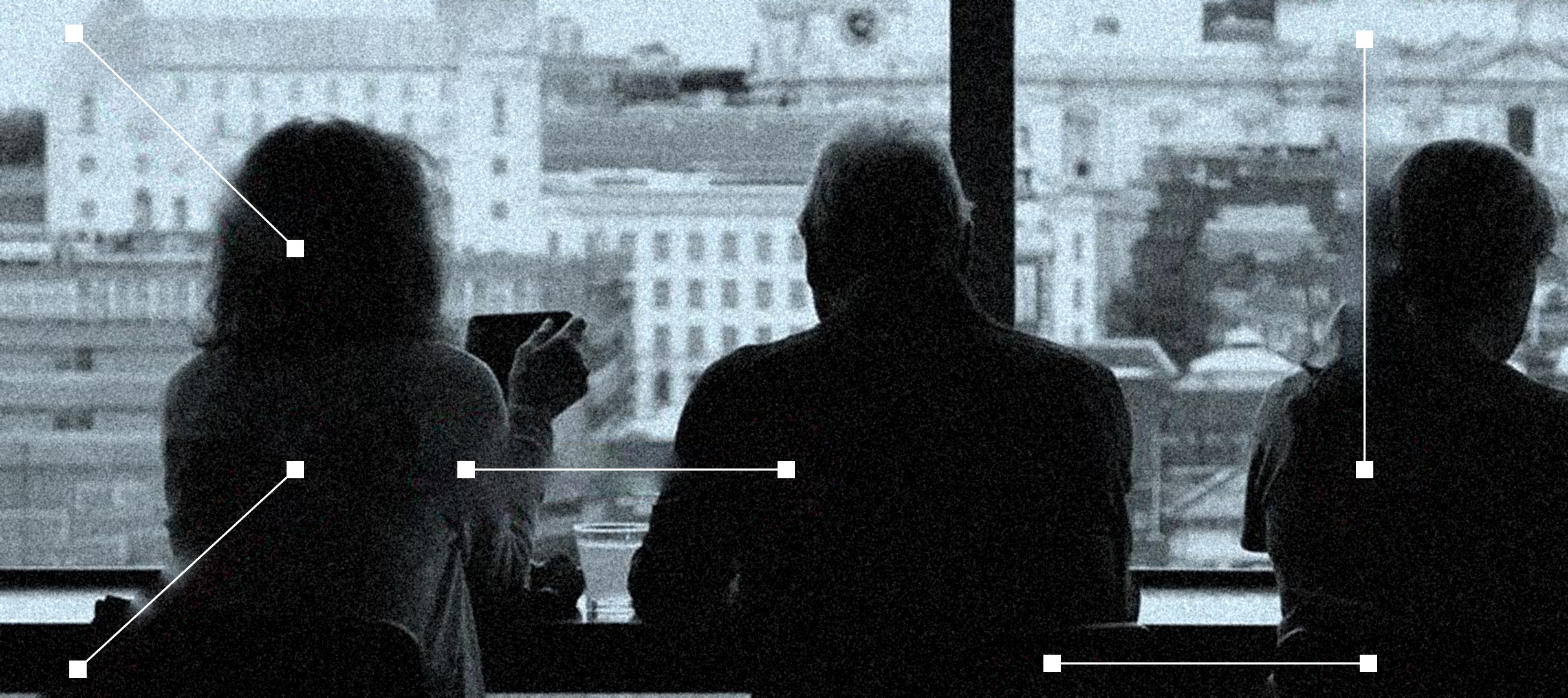 Three people seen from behind at a window over a city, joined by thin white lines with square ends
